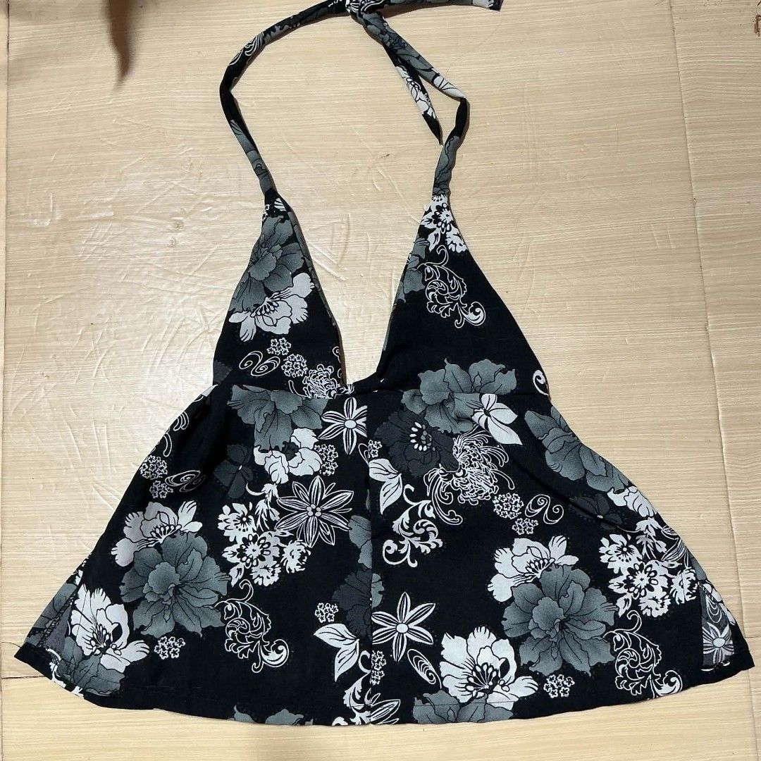 Handmade Self-Tie Black Floral Halter Top (Category: Sleeveless) located in Manila. Submitted by daisyparl (Listing ID 1457016728, Image 1). Description: 🍓 handmade, selftie 🍓 best fits xs-s only 🍓 rfs: did not fit me well :( - Cute black halter top - Grey and white floral print - Ties at the neck - Flowy and lightweight fabric - Ideal for beach days or casual outings - Pairs well with shorts or skirts.