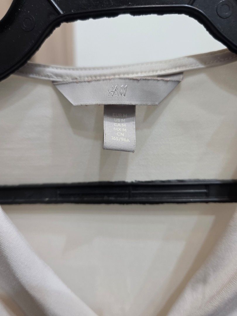 H&M Long Sleeve Ruched Bodysuit Cream (Category: Others Tops) located in Bulacan. Submitted by declutterwithme4 (Listing ID 1457005482, Image 3). Description: - H&M cream long sleeve bodysuit - Features a flattering ruched front detail - Convenient snap button closure at the bottom - Made from soft, comfortable fabric - Versatile piece for layering or wearing solo.