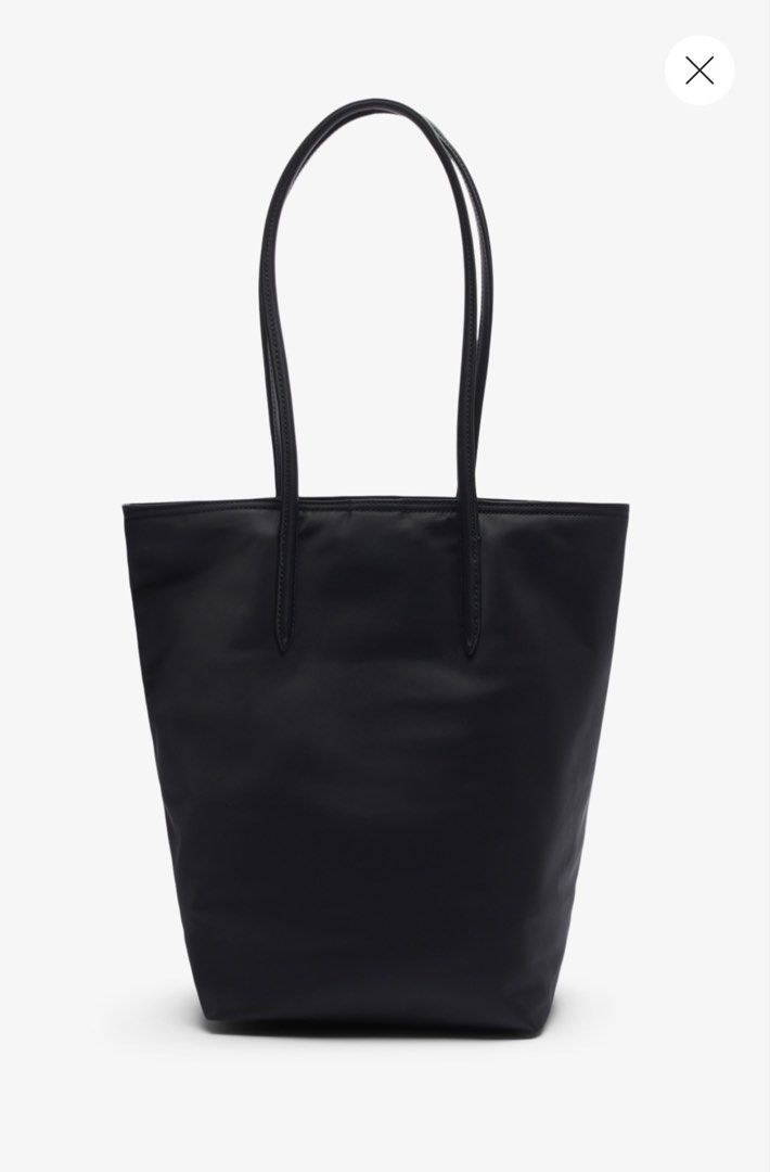 Lacoste Black Vertical Tote Bag (Category: Tote Bags) located in Pasig City. Submitted by _secondchances (Listing ID 1457093009, Image 2). Description: - Classic black Lacoste tote bag - Simple and sleek design - Perfect size for daily essentials - Durable material - Features the iconic Lacoste crocodile logo - Easy to carry with comfortable straps - Great for work or casual outings Used twice only, prefer baby bag Brand new price 6,450 SUPER LIK