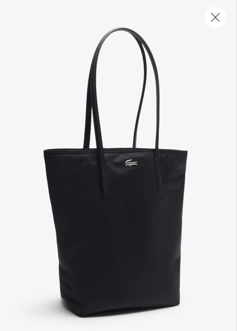 Lacoste Black Vertical Tote Bag (Category: Tote Bags) located in Pasig City. Submitted by _secondchances (Listing ID 1457093009, Image 1). Description: - Classic black Lacoste tote bag - Simple and sleek design - Perfect size for daily essentials - Durable material - Features the iconic Lacoste crocodile logo - Easy to carry with comfortable straps - Great for work or casual outings Used twice only, prefer baby bag Brand new price 6,450 SUPER LIK
