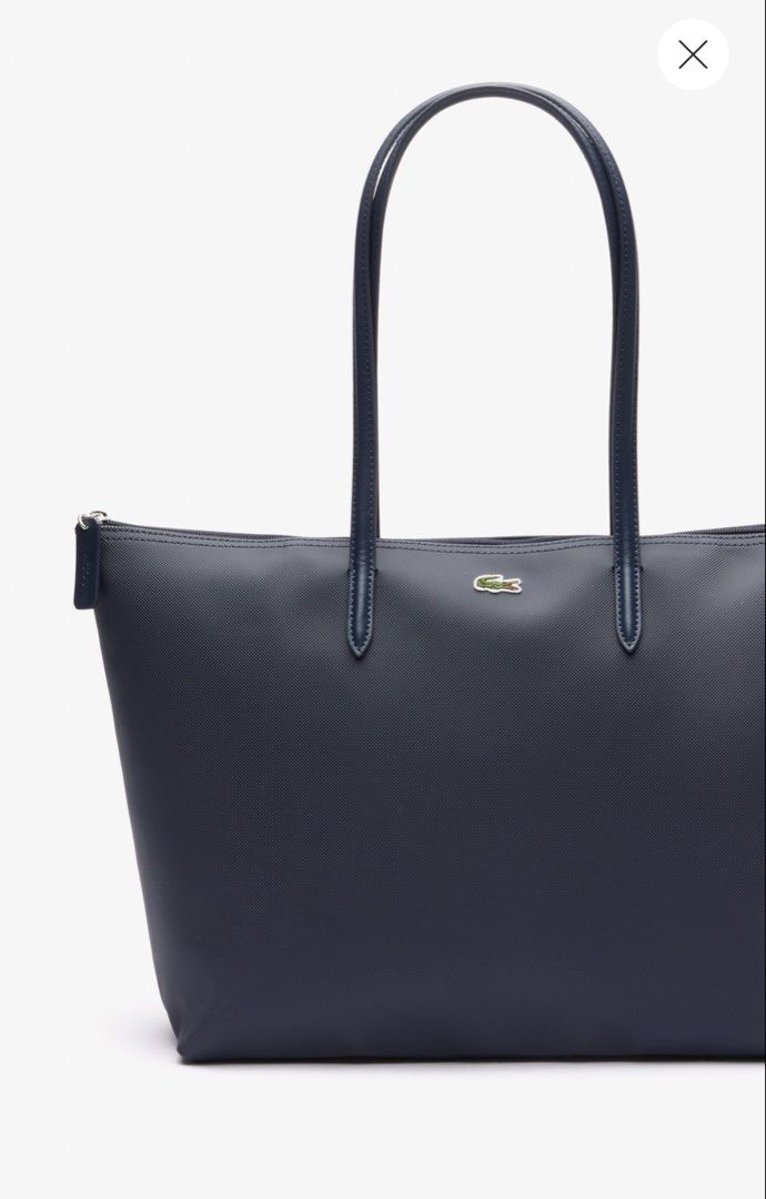 Lacoste Concept Large Tote Bag in Navy Blue (Category: Shoulder Bags) located in Manila. Submitted by everythingbrandedpreloved_ (Listing ID 1457099529, Image 2). Description: • Like new — used only a couple of times • Authentic & original, bought from Lacoste Greenbelt store • Classic Lacoste logo prominently featured on the front • Interior zipper pocket for keeping small essentials secure • Durable, easy-to-maintain leather material • Long str