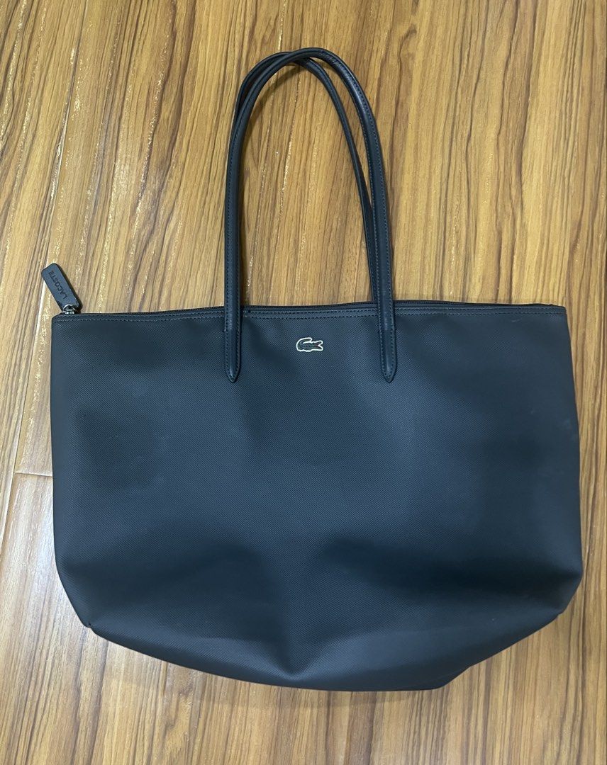 Lacoste Concept Large Tote Bag in Navy Blue (Category: Shoulder Bags) located in Manila. Submitted by everythingbrandedpreloved_ (Listing ID 1457099529, Image 3). Description: • Like new — used only a couple of times • Authentic & original, bought from Lacoste Greenbelt store • Classic Lacoste logo prominently featured on the front • Interior zipper pocket for keeping small essentials secure • Durable, easy-to-maintain leather material • Long str