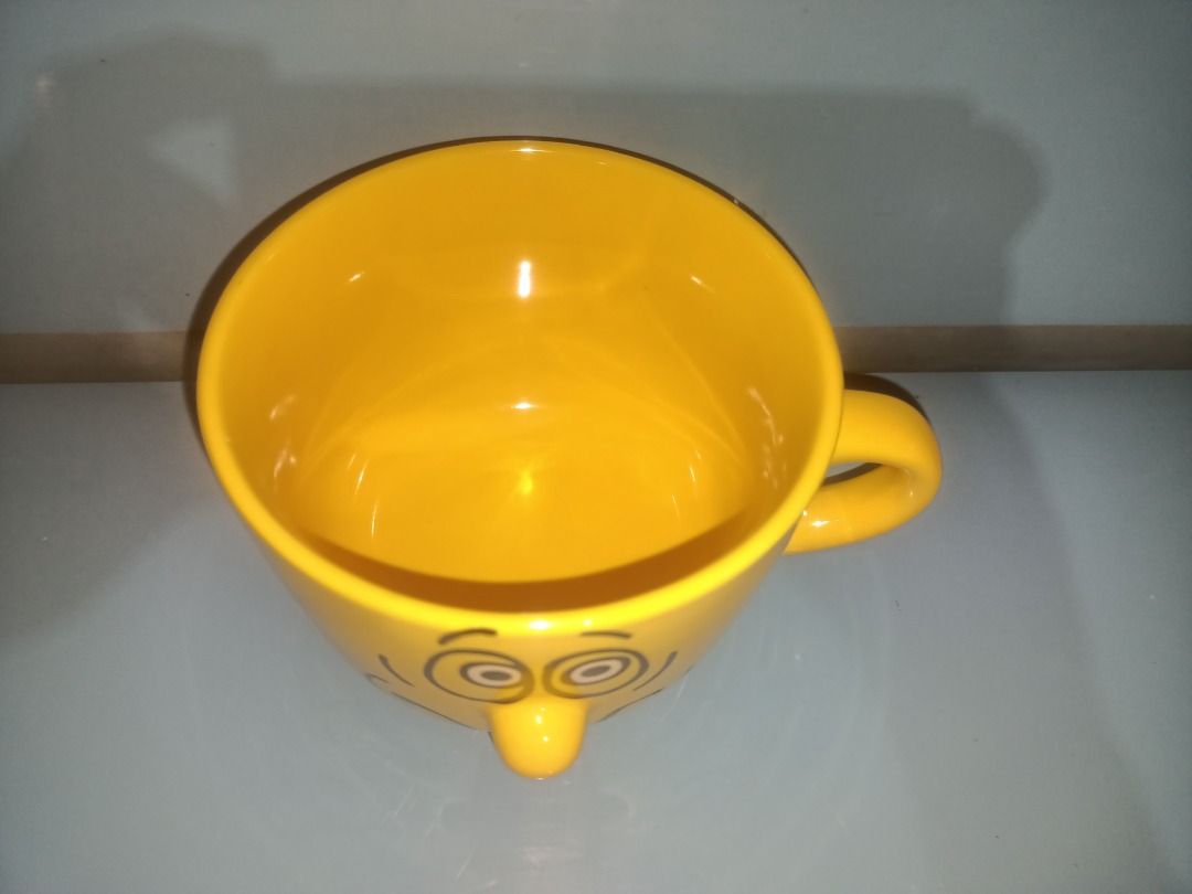 Large 350ml Cute Yellow Smiley Face Mug (Category: Coffee & Tea Tableware) located in Munoz. Submitted by larryc1212 (Listing ID 1457093176, Image 3). Description: - Large, cheerful yellow mug with a smiley face - Small, delicate blue teacup with a charming inner pattern - Includes a matching saucer for the teacup - Ideal for your morning coffee or afternoon tea - Both items are looking for a new home - 350 ml volume Disclaimer: Item may include 