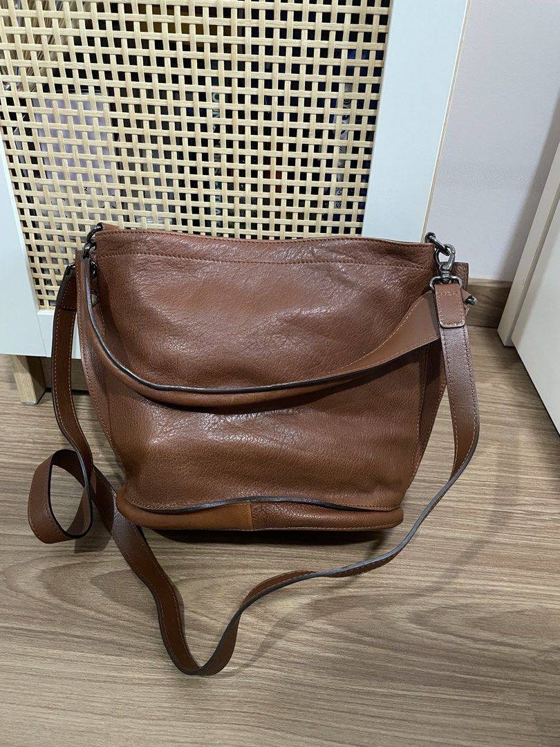 Longchamp Brown Leather Bucket Bag (Category: Luxury Bags & Wallets) located in Quezon City. Submitted by cm_preloved (Listing ID 1456987455, Image 2). Description: - Authentic brown leather Longchamp bucket/shoulder/crossbody bag - Main compartment with interior pockets - Adjustable strap - Includes original tags - Purchased from Rustan's - Original Retail Price: P35,500 - only flaw is the watermark on the exterior.
