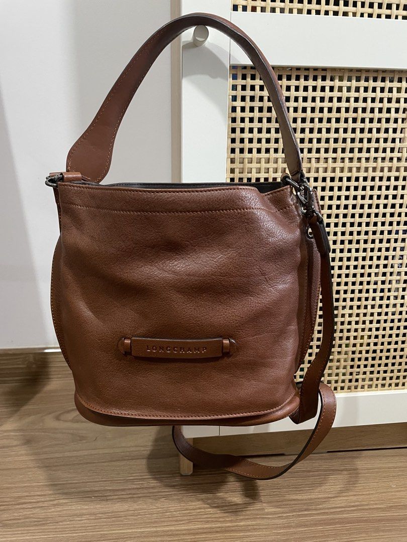 Longchamp Brown Leather Bucket Bag (Category: Luxury Bags & Wallets) located in Quezon City. Submitted by cm_preloved (Listing ID 1456987455, Image 3). Description: - Authentic brown leather Longchamp bucket/shoulder/crossbody bag - Main compartment with interior pockets - Adjustable strap - Includes original tags - Purchased from Rustan's - Original Retail Price: P35,500 - only flaw is the watermark on the exterior.