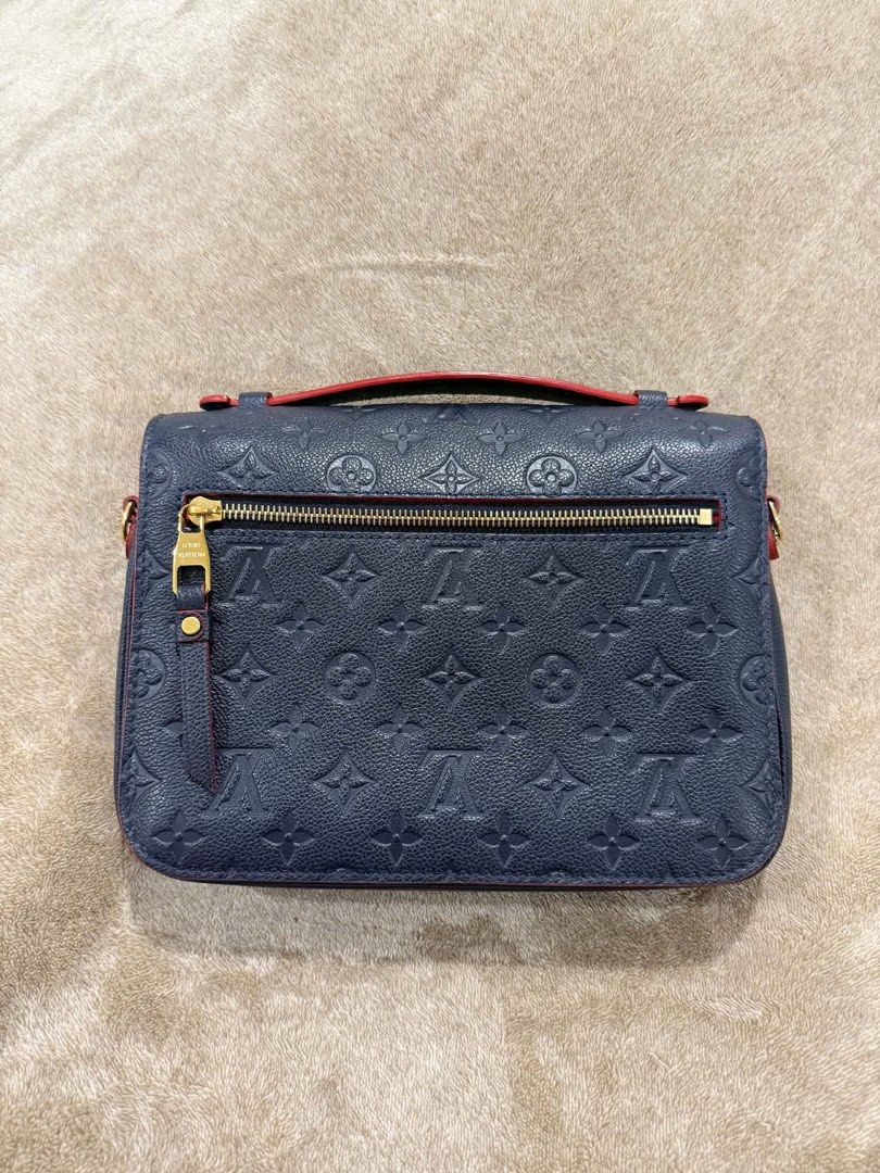 Louis Vuitton Monogram Empreinte Leather Shoulder Bag (Category: Luxury Bags & Wallets) located in Paranaque City. Submitted by lovedstuffby_ang (Listing ID 1456955320, Image 2). Description: Like New LV Monogram Empriente Navy Blue -Used a few times only -Complete inclusions -Store bought in Australia - Navy blue Louis Vuitton bag - Classic monogram empreinte pattern - Red trim detail - Top handle - Detachable shoulder strap - Gold hardware - Zi