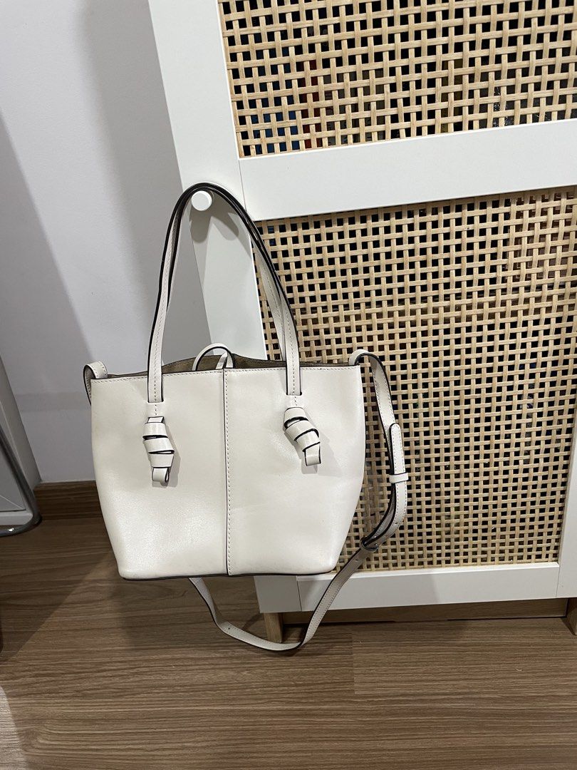 Massimo Dutti White Leather Tote Bag with Knotted Handles (Category: Tote Bags) located in Quezon City. Submitted by cm_preloved (Listing ID 1456987766, Image 2). Description: - White leather micro bag - Brand: Massimo Dutti - Knotted details on handles - With crossbody strap - Suede-like interior lining - Interior pocket - Small mark on front (visible in last photo) Retails for around 8k .