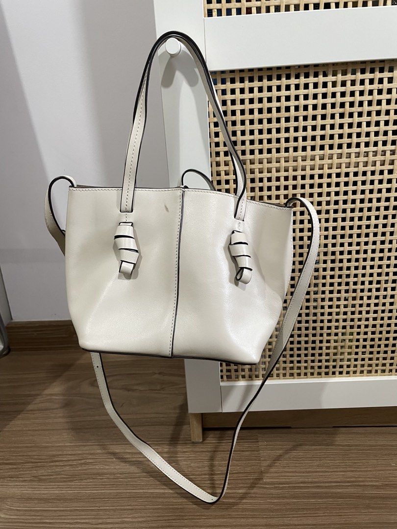 Massimo Dutti White Leather Tote Bag with Knotted Handles (Category: Tote Bags) located in Quezon City. Submitted by cm_preloved (Listing ID 1456987766, Image 1). Description: - White leather micro bag - Brand: Massimo Dutti - Knotted details on handles - With crossbody strap - Suede-like interior lining - Interior pocket - Small mark on front (visible in last photo) Retails for around 8k .