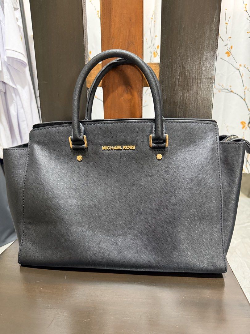 Michael Kors Black Leather Selma (Category: Luxury Bags & Wallets) located in San Juan, Ilocos Sur. Submitted by mklover10 (Listing ID 1456374416, Image 2). Description: - Classic black Michael Kors satchel - Textured leather with gold hardware - Top handles and detachable shoulder strap - Spacious interior for essentials - Versatile for work or casual outings - Clean interior.