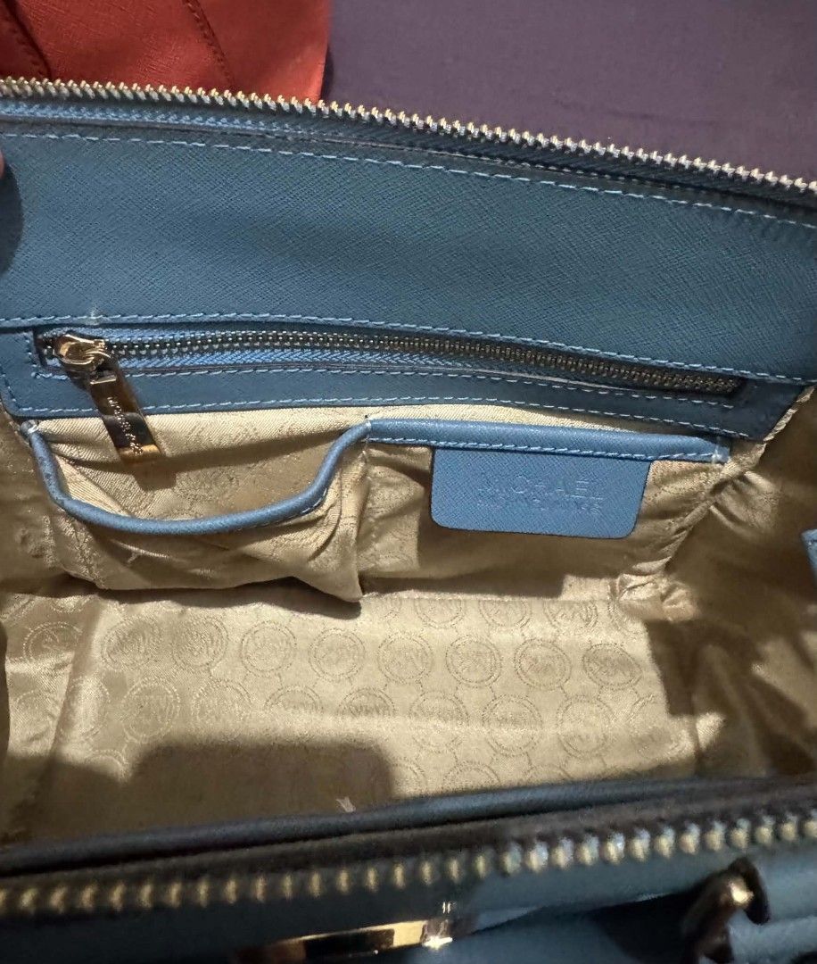 Michael Kors Satchel Handbag Teal Blue (Category: Luxury Bags & Wallets) located in Bacolod City. Submitted by asheroth77 (Listing ID 1457071466, Image 3). Description: - Authentic Michael Kors satchel in a beautiful teal blue color. - Elegant gold hardware details. - Versatile carrying options: top handles and a detachable crossbody strap. - Interior features a zip pocket and slip pockets for organization. - Clean interior..