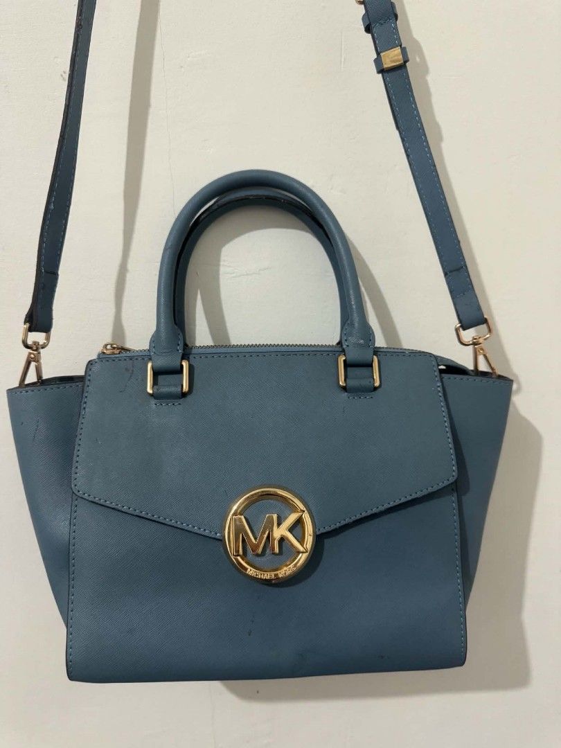 Michael Kors Satchel Handbag Teal Blue (Category: Luxury Bags & Wallets) located in Bacolod City. Submitted by asheroth77 (Listing ID 1457071466, Image 2). Description: - Authentic Michael Kors satchel in a beautiful teal blue color. - Elegant gold hardware details. - Versatile carrying options: top handles and a detachable crossbody strap. - Interior features a zip pocket and slip pockets for organization. - Clean interior..