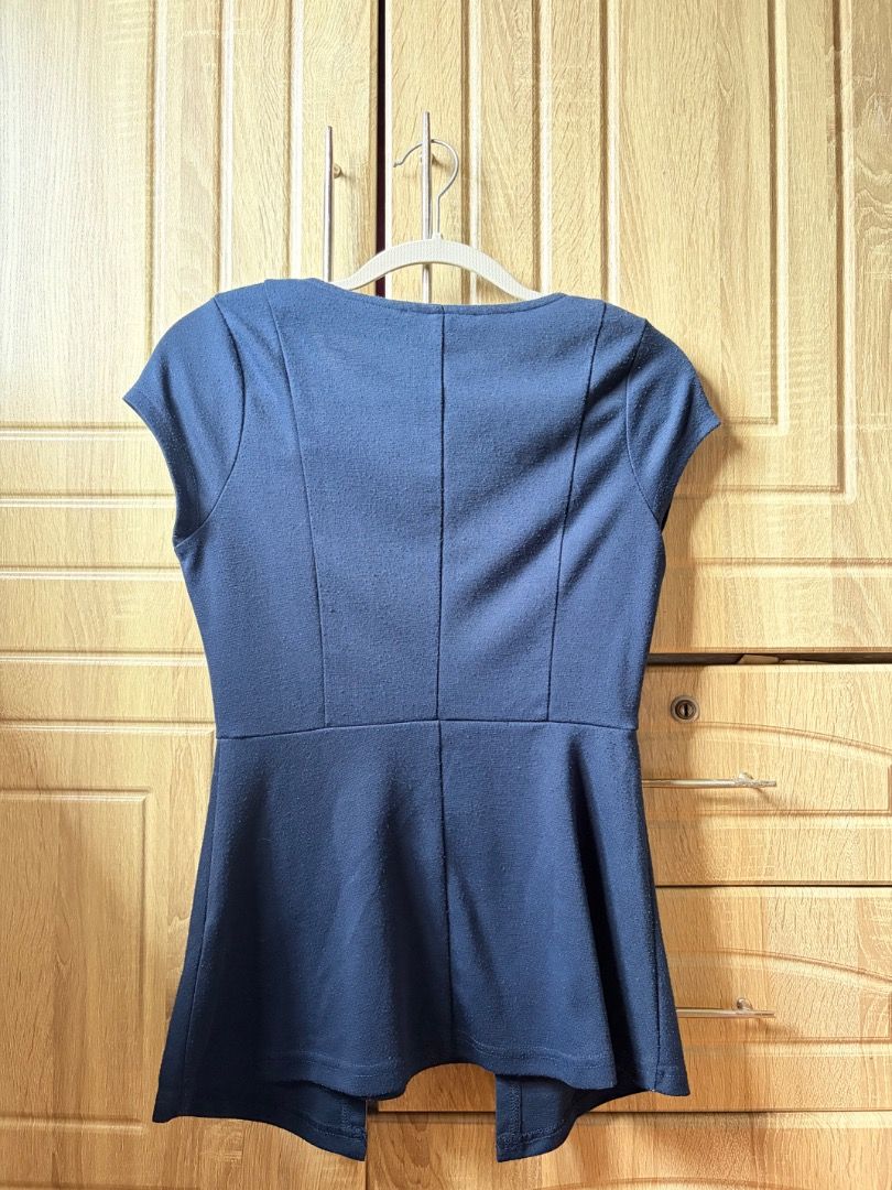 Navy Blue Peplum Top with V-Neck (Category: Sleeveless) located in Tanza. Submitted by kmoarse (Listing ID 1456973851, Image 2). Description: - Navy blue peplum top - V-neckline with short sleeves - Fitted waist with flared hem - Estimated size S or M - Versatile for work or casual outfits - Classic and simple design.