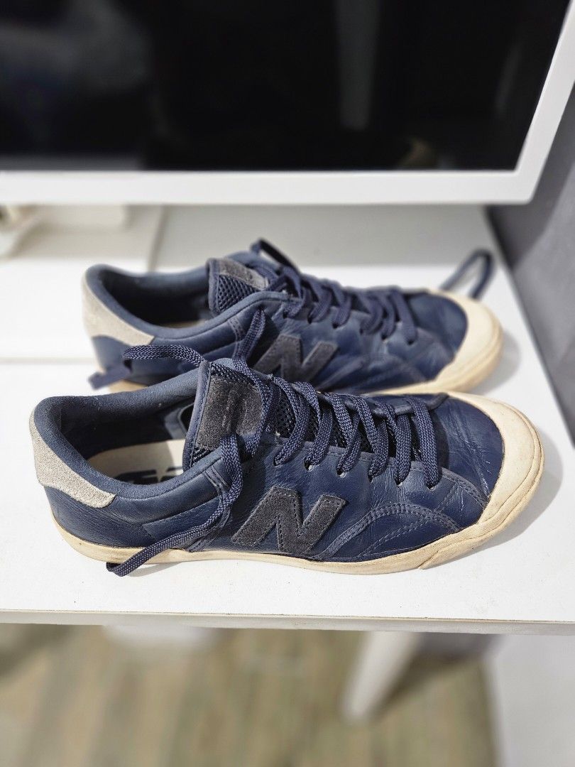 OG New Balance Pro Court Low (Category: Casual Shoes) located in Pasay City. Submitted by pass.it.on.ph (Listing ID 1457129006, Image 2). Description: Model: New Balance Pro Court Low ​Style/Model Code: PROCTSOC (Manufacturing Date: 07/2017) ​Size: US 7.5 / UK 7 / EU 40.5 / 25.5 CM ​Width: D (Standard Men's Width) ​Materials: Navy blue pebbled leather upper, suede logo/heel patch, and a textured rubber cupsole. ​Upper Leather: The navy blue leath