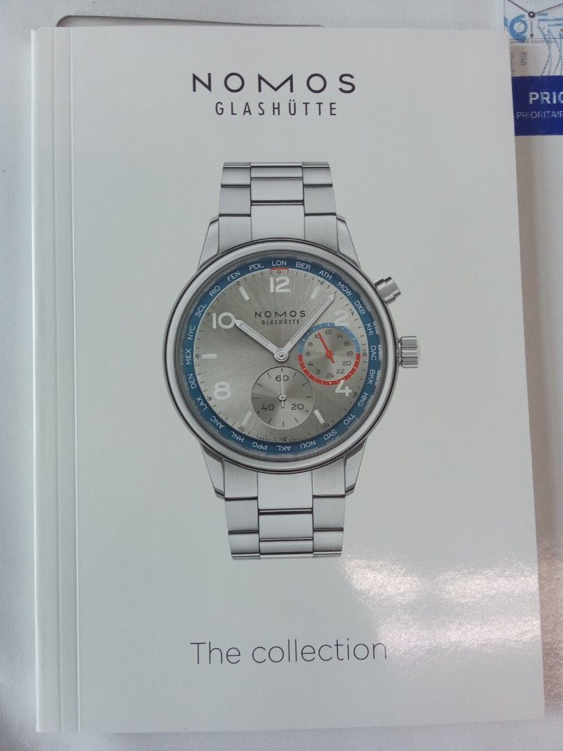 NOMOS Glashütte "The Collection" Watch Catalog (Category: Men's Watches) located in Pasig City. Submitted by teebeedeee (Listing ID 1457138314, Image 2). Description: - NOMOS Glashütte 'The Collection' catalog - Features popular models like Tangente, Ahoi, Metro, and others - Includes detailed information on watch calibers and manufacturing processes - An excellent reference for watch enthusiasts and collectors - Visit nomos-glashuette.com for a 