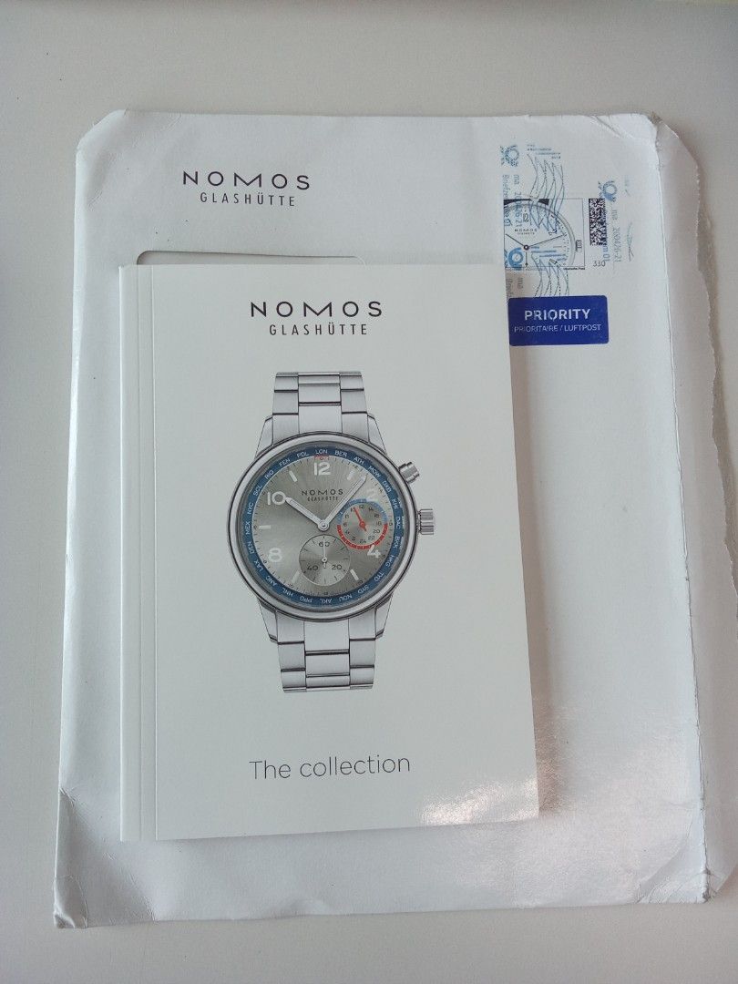 NOMOS Glashütte "The Collection" Watch Catalog (Category: Men's Watches) located in Pasig City. Submitted by teebeedeee (Listing ID 1457138314, Image 1). Description: - NOMOS Glashütte 'The Collection' catalog - Features popular models like Tangente, Ahoi, Metro, and others - Includes detailed information on watch calibers and manufacturing processes - An excellent reference for watch enthusiasts and collectors - Visit nomos-glashuette.com for a 
