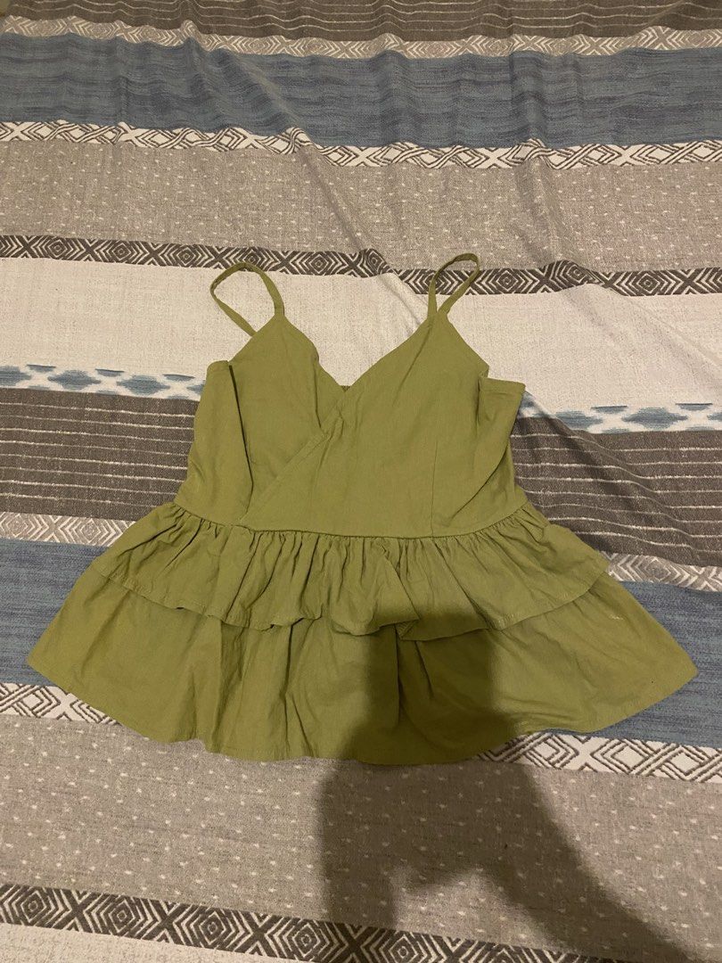 Olive Green Smocked Ruffle Camisole Top (Category: Sleeveless) located in Tanauan. Submitted by rie098 (Listing ID 1457061323, Image 1). Description: - Never worn - Cute olive green camisole top - Smocked back for a snug fit - Ruffle detailing on the hem - Versatile for casual outings or dressing up.