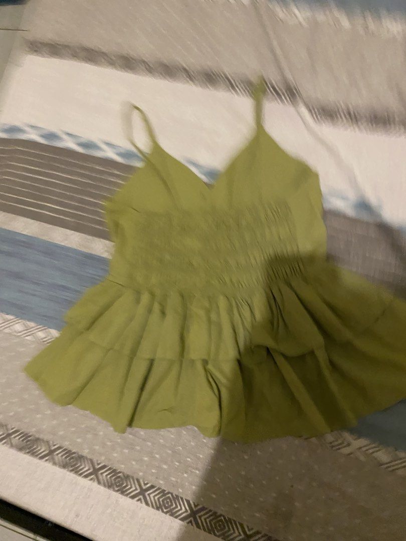 Olive Green Smocked Ruffle Camisole Top (Category: Sleeveless) located in Tanauan. Submitted by rie098 (Listing ID 1457061323, Image 3). Description: - Never worn - Cute olive green camisole top - Smocked back for a snug fit - Ruffle detailing on the hem - Versatile for casual outings or dressing up.