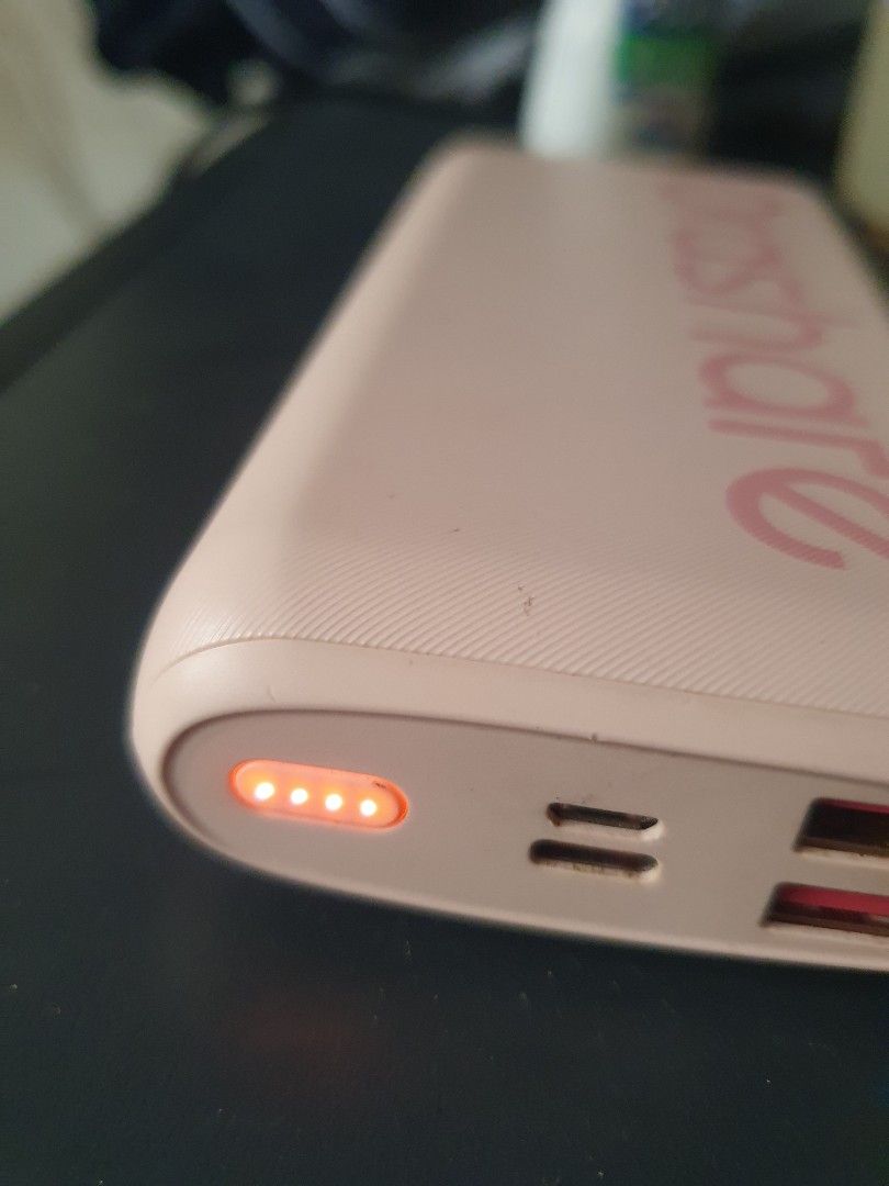 Orashare 20000mAh Power Bank (Category: Batteries & Power Banks) located in Caloocan City. Submitted by j3ffr3y16 (Listing ID 1457140477, Image 2). Description: Orashare 20000mAh power bank. Pink color. Has USB Type-C input and USB output. Four indicator lights show battery level. Model is OZB080-105. Made in China. Still has charge, lights are on. Great for charging devices on the go..