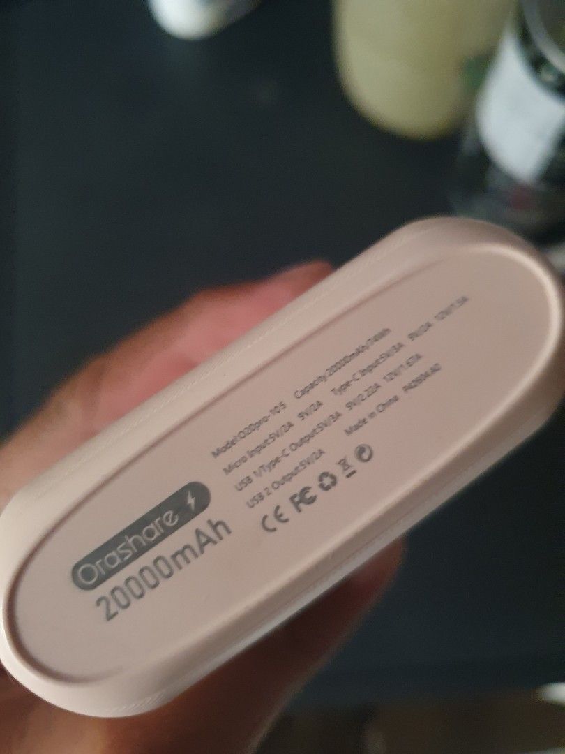 Orashare 20000mAh Power Bank (Category: Batteries & Power Banks) located in Caloocan City. Submitted by j3ffr3y16 (Listing ID 1457140477, Image 3). Description: Orashare 20000mAh power bank. Pink color. Has USB Type-C input and USB output. Four indicator lights show battery level. Model is OZB080-105. Made in China. Still has charge, lights are on. Great for charging devices on the go..