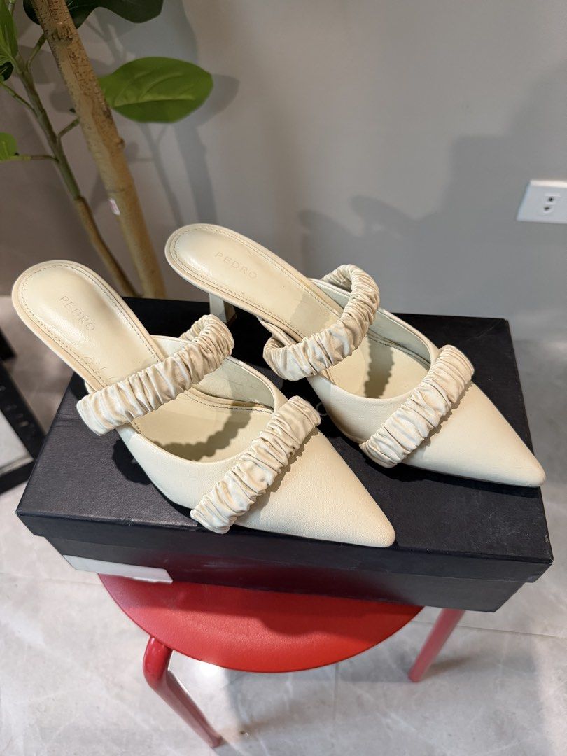 PEDRO Cream Ruched Pointed Toe Mules Heels (Category: Heels) located in Caloocan City. Submitted by hellomaryon (Listing ID 1457015887, Image 2). Description: Authentic PEDRO pointed-toe slip-on mules in a versatile cream / chalk white color. Features a soft ruched / scrunchie-style vamp strap that adds an elegant, modern accent to any look. ✨ Comes with original PEDRO shoebox pictured ✨ Great for work, casual chic outfits, brunch, or minimalist 