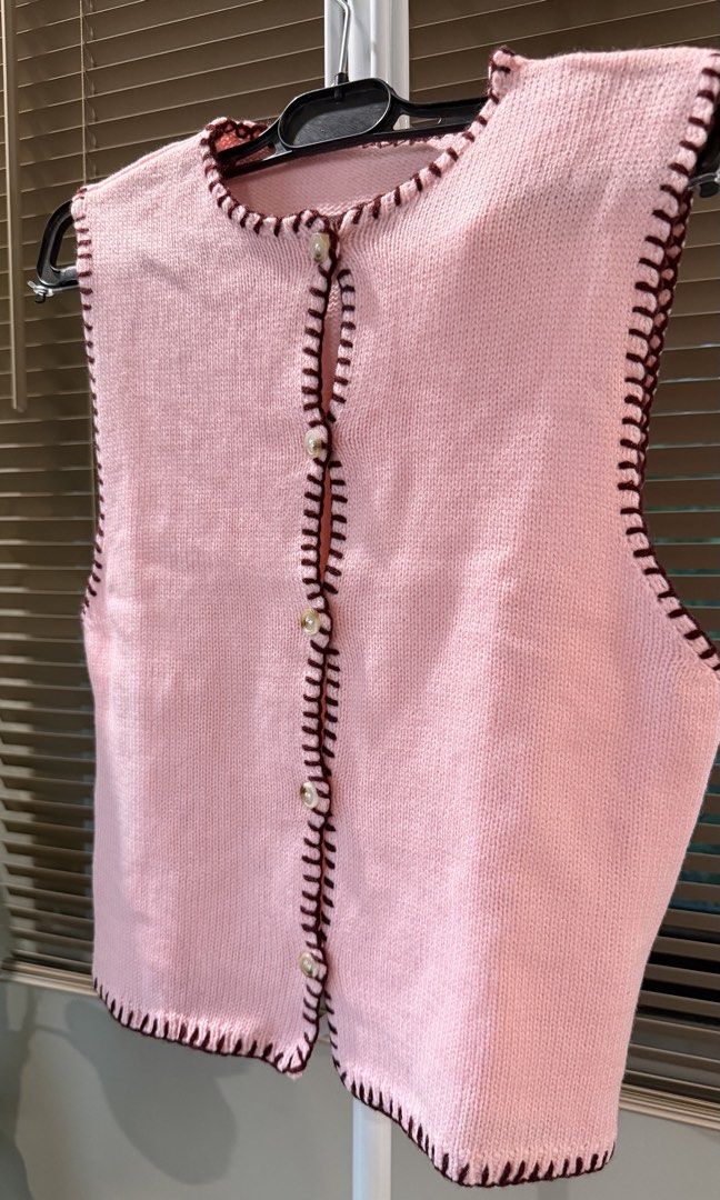 Pink Knit Cardigan Vest with Button Front (Category: Coats, Jackets and Outerwear) located in Caloocan City. Submitted by hellomaryon (Listing ID 1457015888, Image 3). Description: Selling this super cute light pink sleeveless knit vest top! Features dark maroon contrast blanket-stitch detailing along all the edges and vintage-style pearl buttons down the front. ✨ Sleeveless knit cardigan vest / button-up vest ✨ Dark contrast trim whipstitching ✨