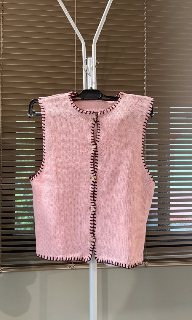 Pink Knit Cardigan Vest with Button Front (Category: Coats, Jackets and Outerwear) located in Caloocan City. Submitted by hellomaryon (Listing ID 1457015888, Image 2). Description: Selling this super cute light pink sleeveless knit vest top! Features dark maroon contrast blanket-stitch detailing along all the edges and vintage-style pearl buttons down the front. ✨ Sleeveless knit cardigan vest / button-up vest ✨ Dark contrast trim whipstitching ✨