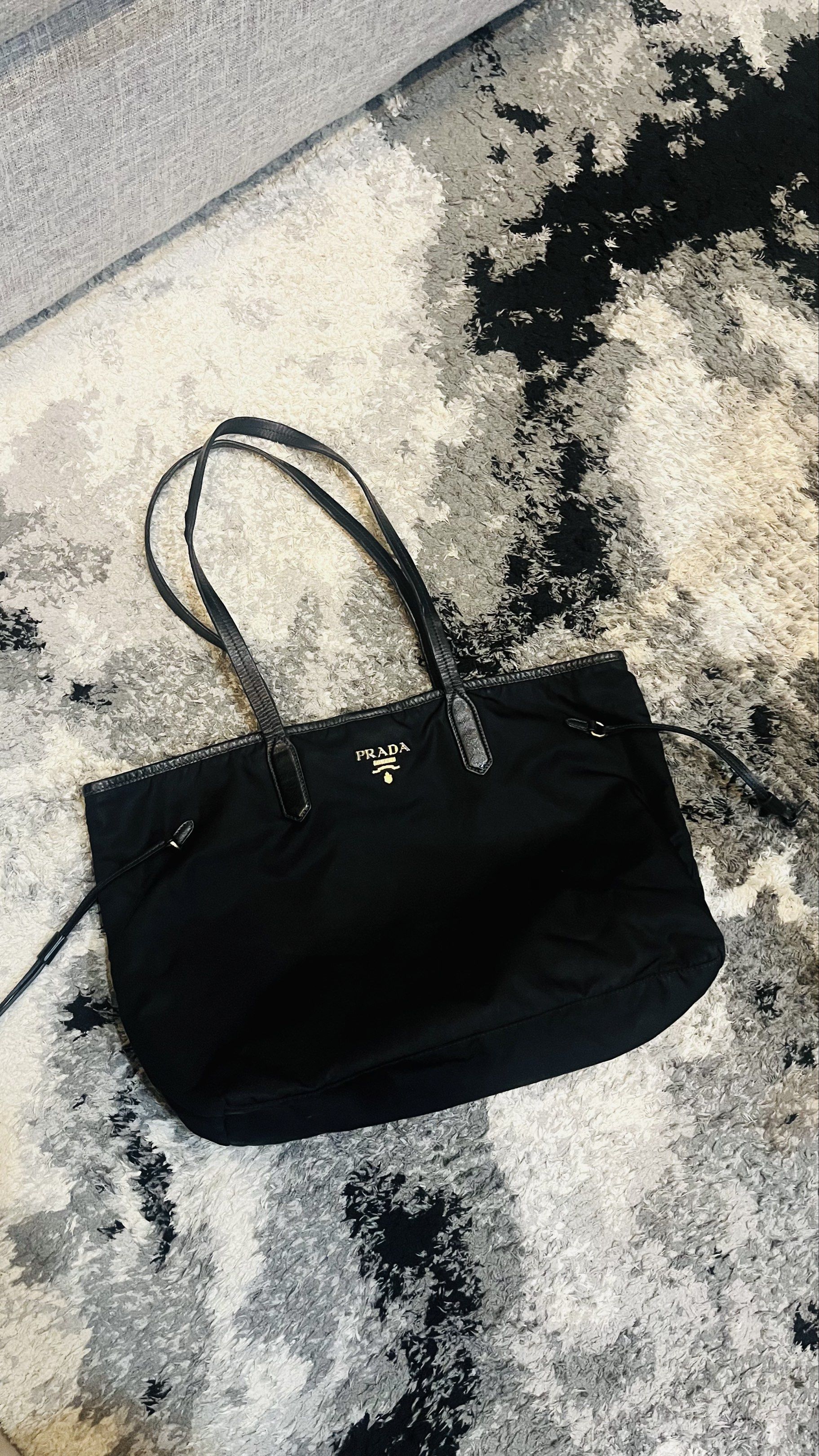 Prada Nylon Tessuto Tote Bag Black (Category: Luxury Bags & Wallets) located in Makati City. Submitted by jlohclaire (Listing ID 1457101939, Image 1). Description: - Authentic Prada tote bag - Color: Black - Material: Nylon with leather trim and handles - Features: Spacious interior - Origin: Made in Italy - Style: Classic and versatile for everyday use - this is a project Bag. Need to repair some part of the handle strap that that’s why I’m sell