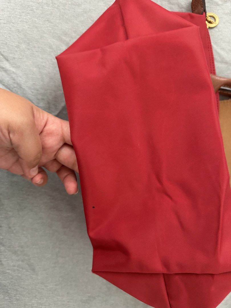Pre loved Longchamp Le Pliage Red Top Handle Bag (Category: Luxury Bags & Wallets) located in Quezon City. Submitted by ono11 (Listing ID 1457008964, Image 2). Description: - Authentic Red Longchamp Le Pliage small Bag - Top Handle Style - Durable Nylon Body with Leather Trim - Secure Zipper Closure - Convenient Inside Pocket - Minor dark mark on the side (visible in photos) - Elegant Gold Hardware.