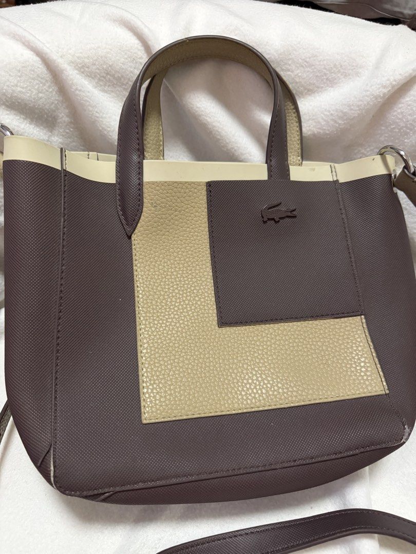 PRELOVED Lacoste Anna Contrast Tote Bag (Category: Cross-body Bags) located in Santa Cruz. Submitted by vendrenee (Listing ID 1456983992, Image 1). Description: Lacoste Two-Tone Tote Bag 🤎 Authentic Lacoste • Spacious & stylish Brown & beige colorway with signature crocodile logo. Comes with shoulder strap. Please see photos for visible flaws/edge wear. Priced accordingly. PM for measurements/details..