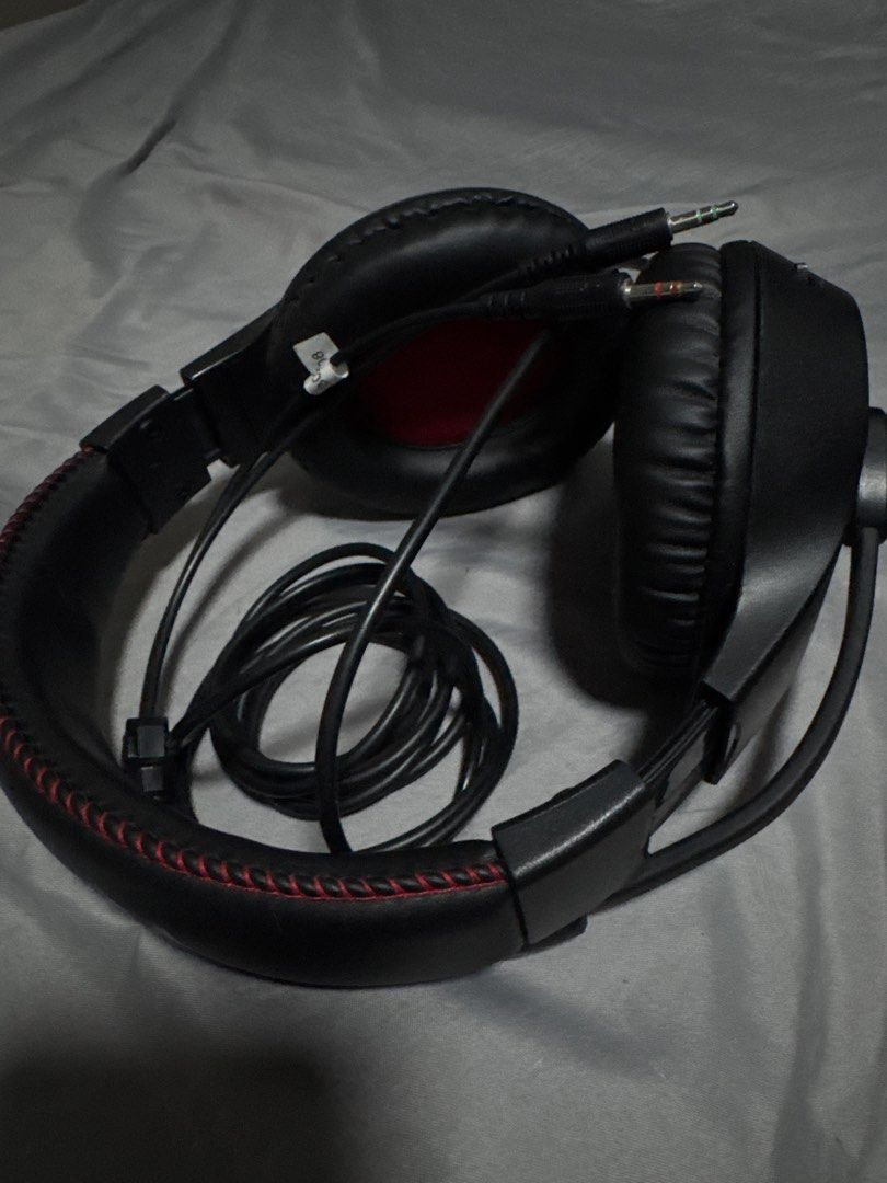 Redragon Gaming Headset with Microphone (Category: Headphones & Headsets) located in Las Pinas. Submitted by y0sh1ee (Listing ID 1456968289, Image 2). Description: - Redragon Gaming Headset - Color: Black with red stitching detail - Built-in microphone - Dual 3.5mm jack connectors - Ideal for gaming and general audio use - Neat, coiled cable - Ready for a new owner -No issues -Like new.