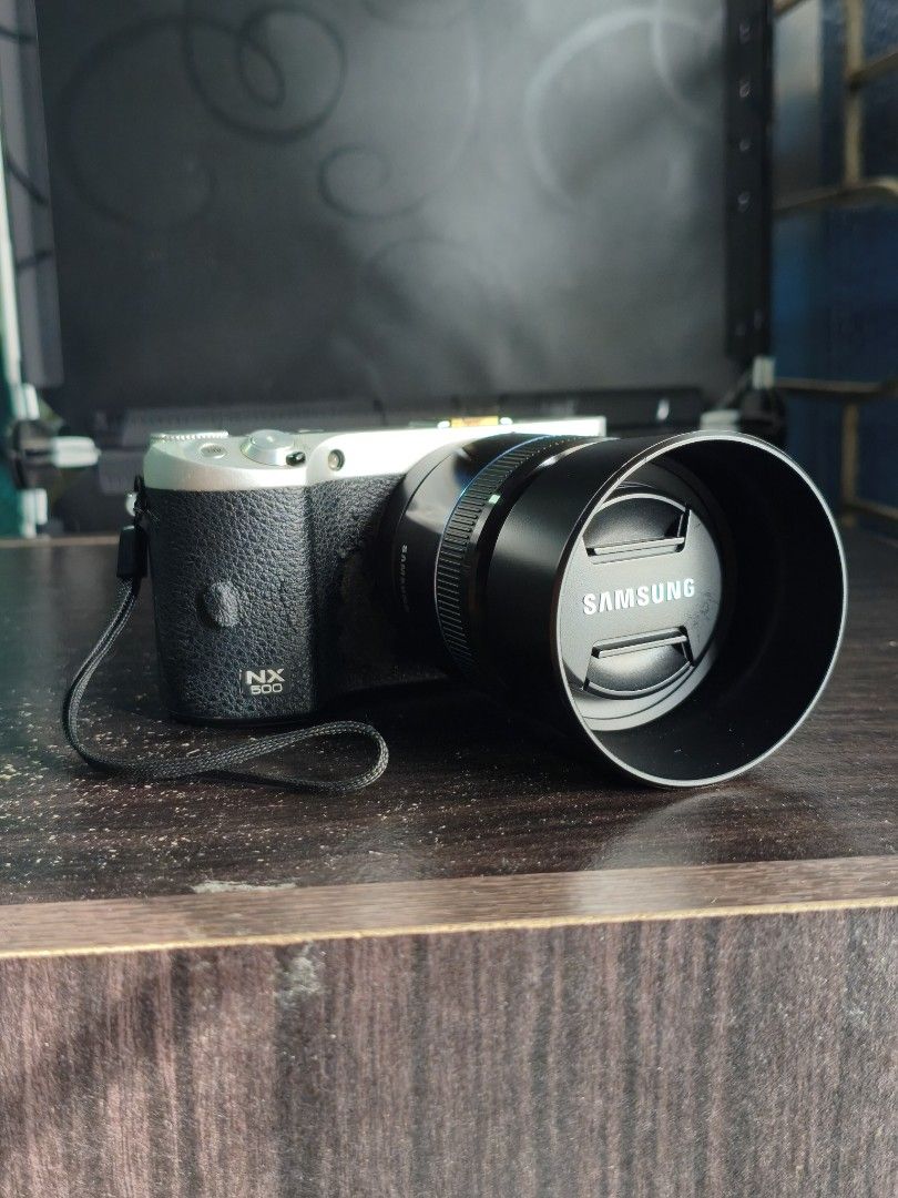 Samsung NX 500 Mirrorless Camera (Category: Cameras) located in Dagupan City. Submitted by jmszn (Listing ID 1457054257, Image 1). Description: Samsung NX 500 Mirrorless Camera - 28.2 MP BSI APS-C CMOS - With custom hotshoe cover - Flippable SUPER AMOLED screen - Issue: Leather wearing out, but does not affect performance. - Lens has small fungus but does not affect performance. PM for the picture. Inclusions: - 45mm F1.8 Prime Lens (worth ₱8k) -