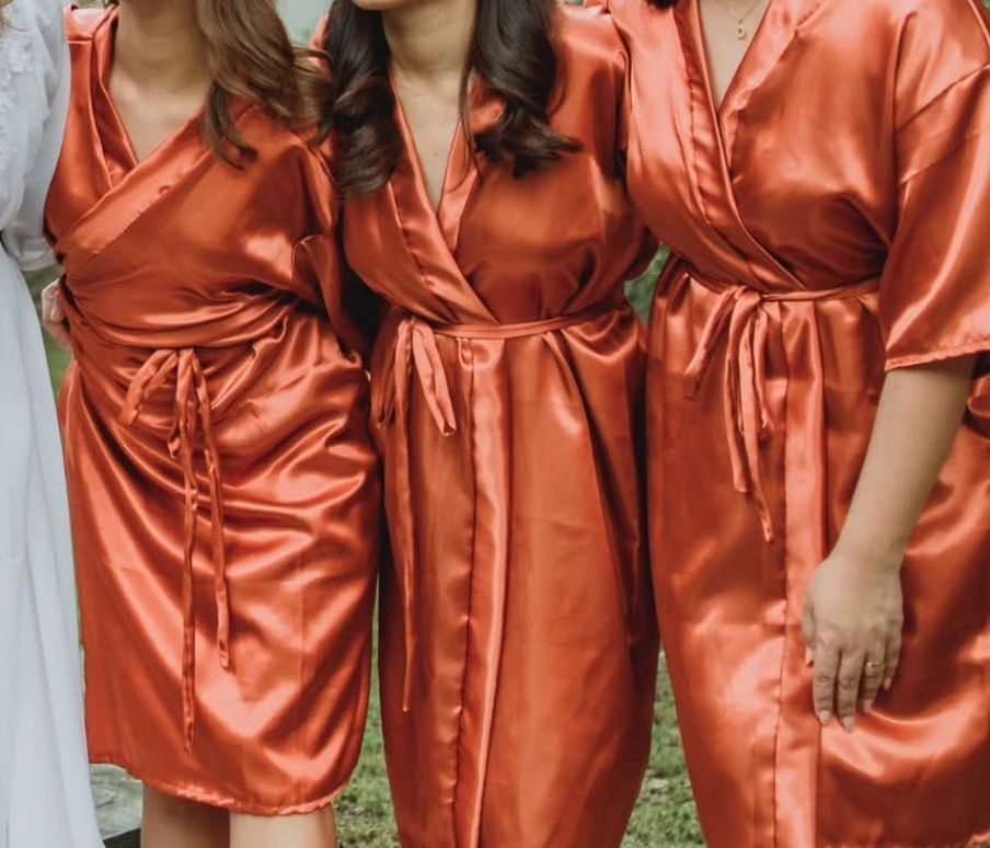 Satin Robe - Burnt Orange Bridesmaid Robe (Category: Undergarments & Loungewear) located in Tanza. Submitted by kmoarse (Listing ID 1457083228, Image 2). Description: - Beautiful burnt orange satin robes - Perfect for wedding day prep or as a bridesmaid gift - Silky smooth material for ultimate comfort - Features a tie at the waist for a customizable fit - Short length for a chic and breezy feel - Available in a range of sizes to fit everyone - U