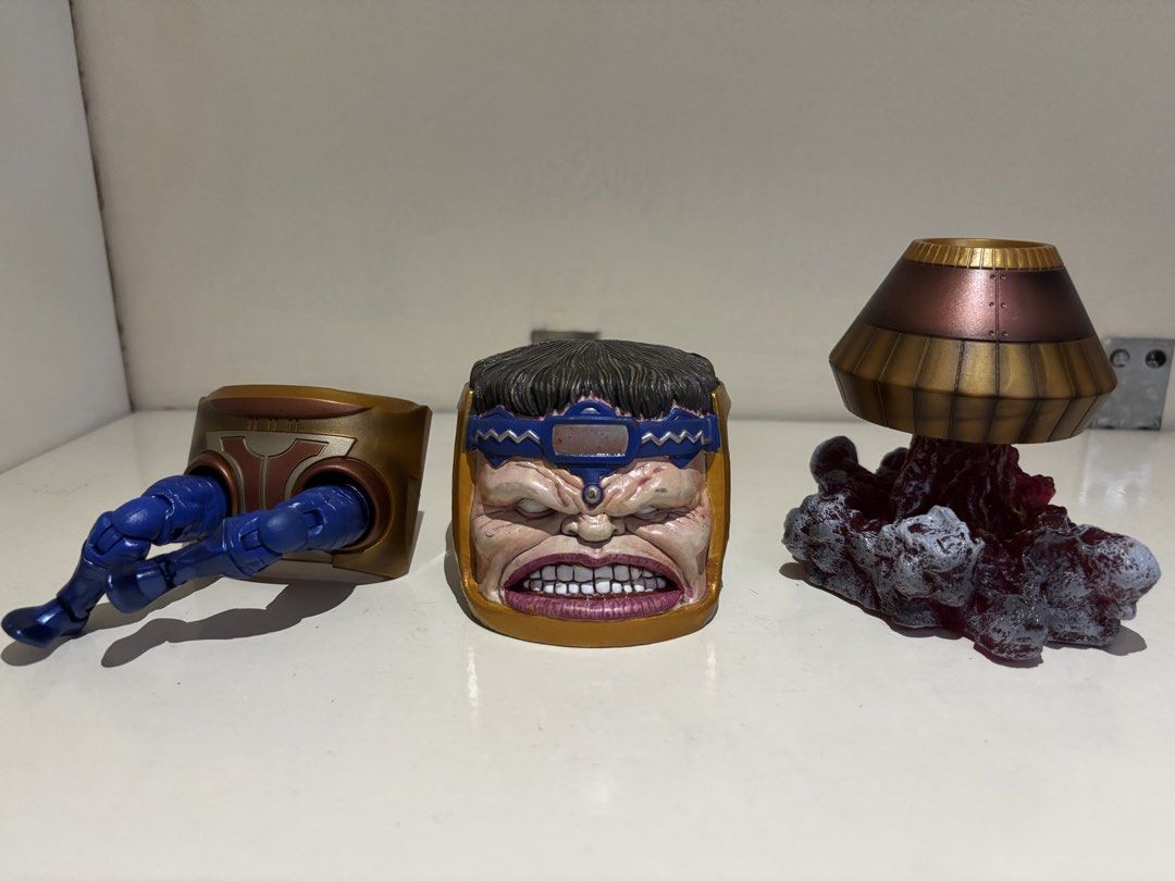 [SET] Marvel Legends M.O.D.O.K. BAF Parts (Category: Figurines & Statues) located in Angeles City. Submitted by deyninazd (Listing ID 1457107440, Image 1). Description: The classic Marvel Legends M.O.D.O.K.! Great for collectors looking to complete the villain without buying individual figures. Included Parts: Head & Face Unit: High-detail angry expression sculpt, blue headband, and gold casing frame. Lower Chair & Legs: Metallic gold/bronze chai