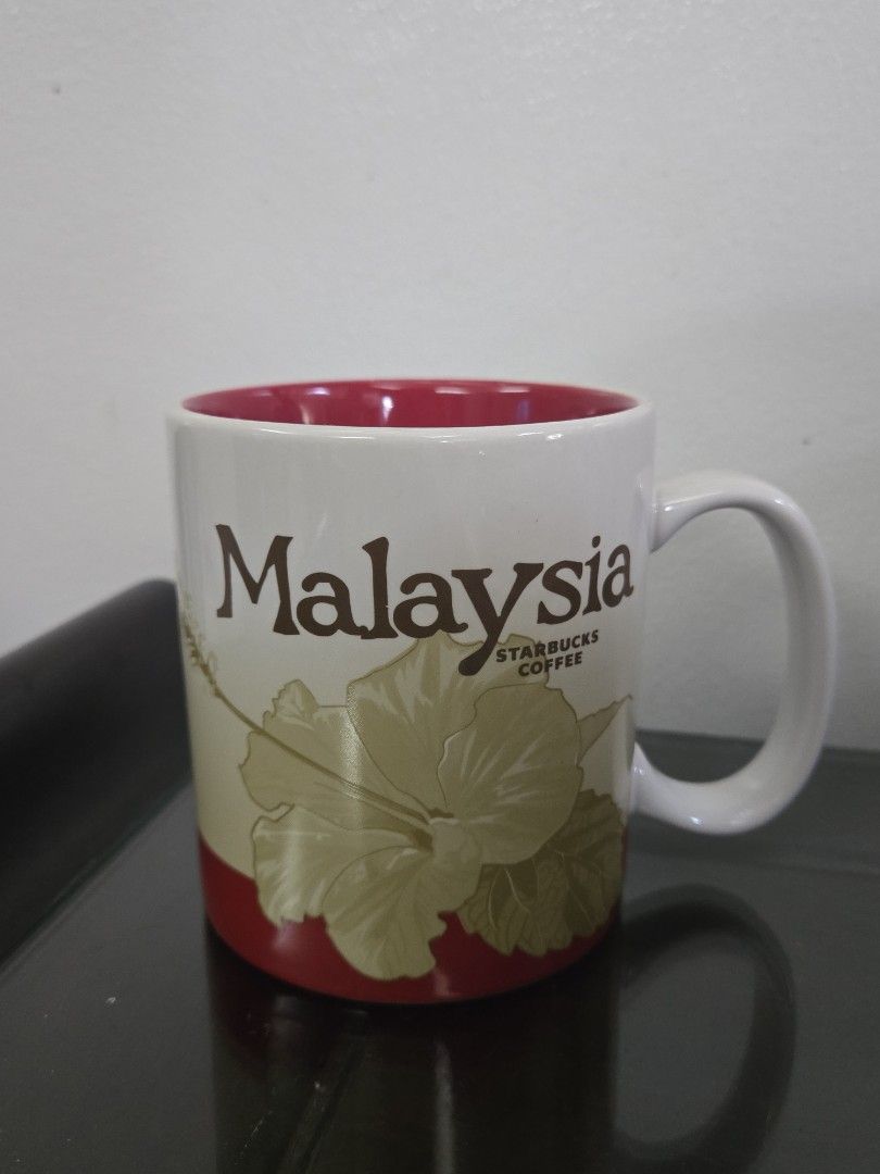 Starbucks Coffee Malaysia Mug 16oz (Category: Coffee & Tea Tableware) located in Quezon City. Submitted by samcas (Listing ID 1456964727, Image 1). Description: Starbucks Malaysia mug, 16oz. Features hibiscus and city skyline. Red interior. Stoneware, microwave/dishwasher safe..