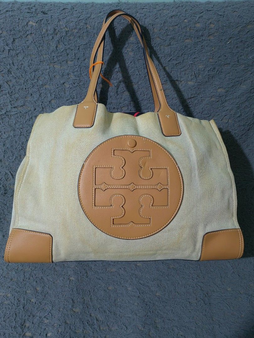 Tory Burch Canvas & Leather Tote Bag (Category: Luxury Bags & Wallets) located in Las Pinas. Submitted by huslerz (Listing ID 1456991367, Image 1). Description: - Classic Tory Burch tote bag - Beige canvas with tan leather trim - Iconic double T logo - Spacious interior, ideal for everyday or travel - Some signs of wear on canvas (as pictured) - Stylish and practical.