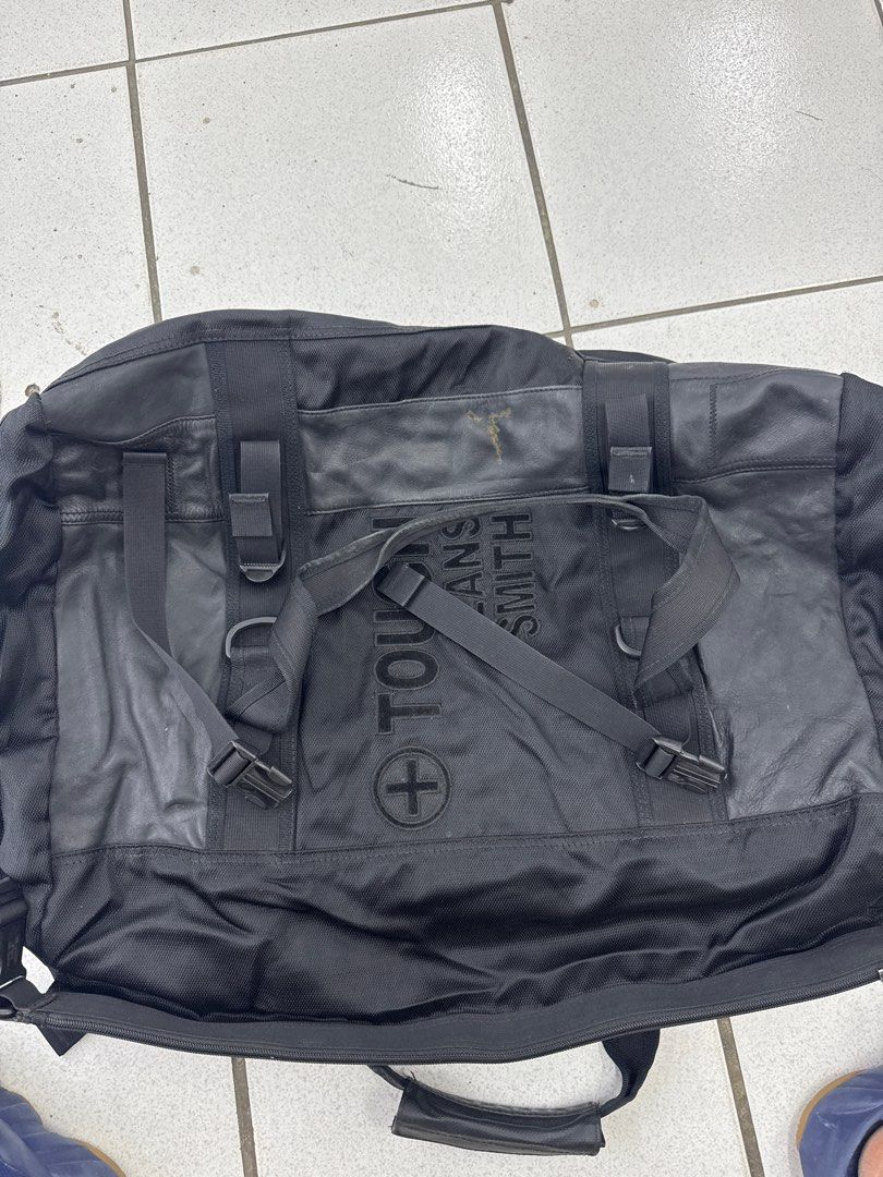 Tough Jeans Smith Black Duffel Bag (Category: Luxury Bags & Wallets) located in Mandaluyong City. Submitted by darscarousel (Listing ID 1457077420, Image 2). Description: Selling my TOUGH Jeansmith duffel bag in black. • Material: Heavy-duty canvas/nylon blend with leather accents and durable hardware. • Features: Very spacious, perfect for weekend trips, travel, or gym use. Includes multiple adjustable straps, buckles, and the classic embroidere