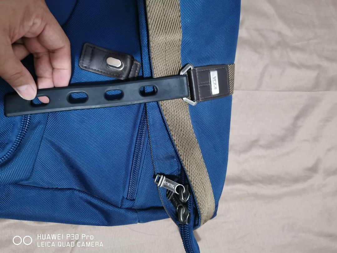 Tumi Backpack Blue Nylon Roll Top (Category: Backpacks) located in Makati City. Submitted by relianzmae57131 (Listing ID 1457072777, Image 2). Description: - Blue Tumi backpack, authenticity not guaranteed - Roll-top design with adjustable strap - Multiple exterior pockets with zippers - Interior compartments for organization - Durable nylon material - Ideal for daily use or travel.