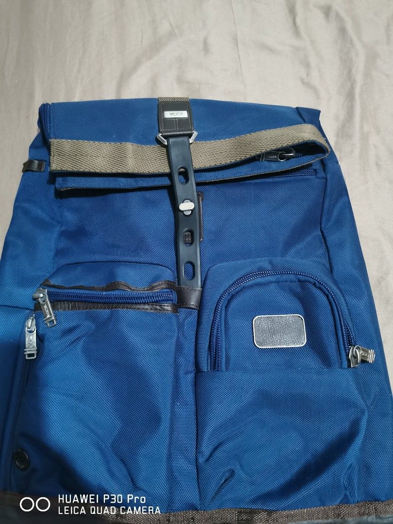 Tumi Backpack Blue Nylon Roll Top (Category: Backpacks) located in Makati City. Submitted by relianzmae57131 (Listing ID 1457072777, Image 3). Description: - Blue Tumi backpack, authenticity not guaranteed - Roll-top design with adjustable strap - Multiple exterior pockets with zippers - Interior compartments for organization - Durable nylon material - Ideal for daily use or travel.