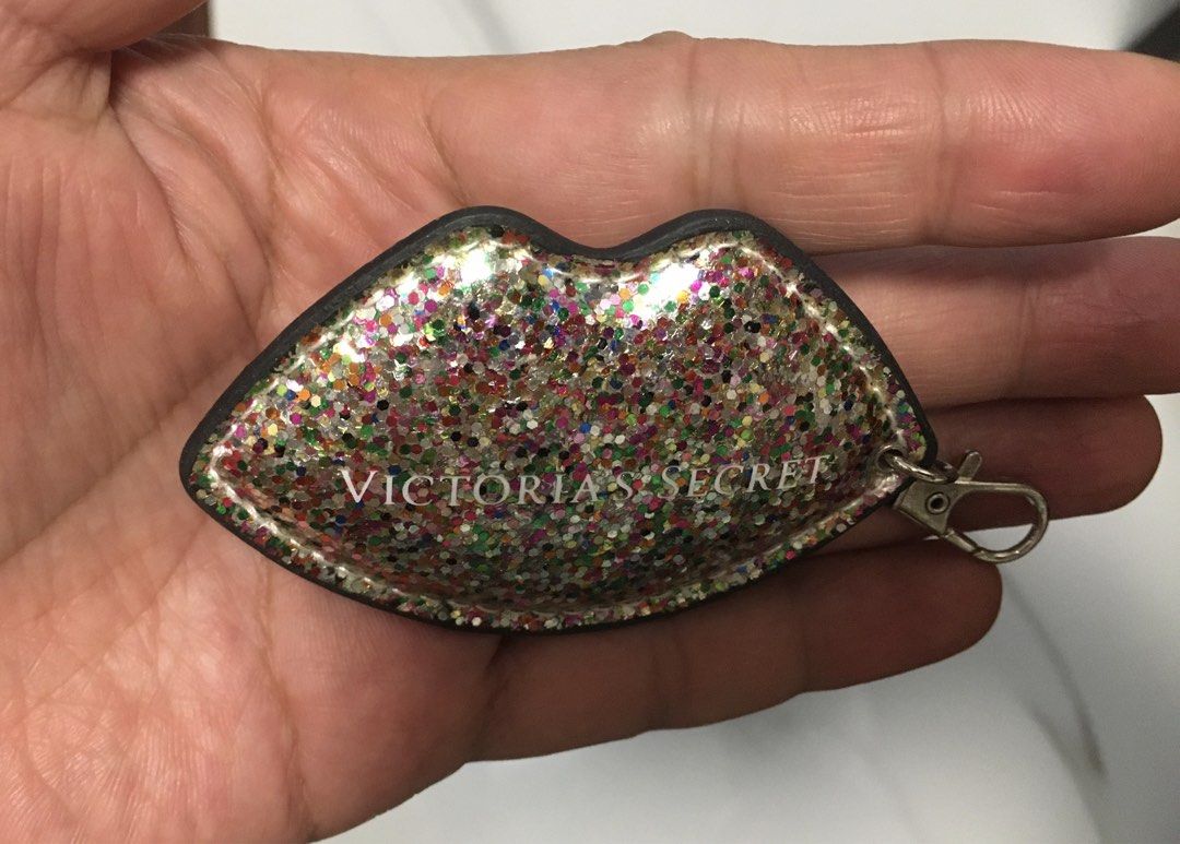 Victoria's Secret Glitter Lips Keychain Charm (Category: Other Accessories) located in Pasay City. Submitted by gilbertso62551 (Listing ID 1457057442, Image 3). Description: - Cute Victoria's Secret keychain - Shaped like lips with glitter - Features Victoria's Secret logo on both sides - Comes with a silver clip - Ideal for decorating bags or keys - Adds a touch of sparkle - As is,where is - Not BrandNew .