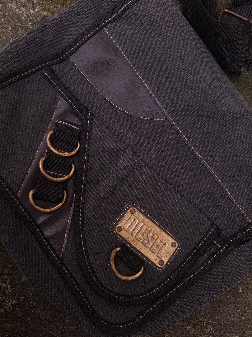 Vintage Diesel Canvas Messenger Bag (Category: Sling Bags) located in Manila. Submitted by bonaobrag55538 (Listing ID 1456981550, Image 3). Description: - Authentic vintage Diesel messenger bag - Durable dark grey canvas material - Ample interior space for your essentials - Comfortable adjustable strap - Perfect for everyday use - Issue: 1 change zipper fuller.