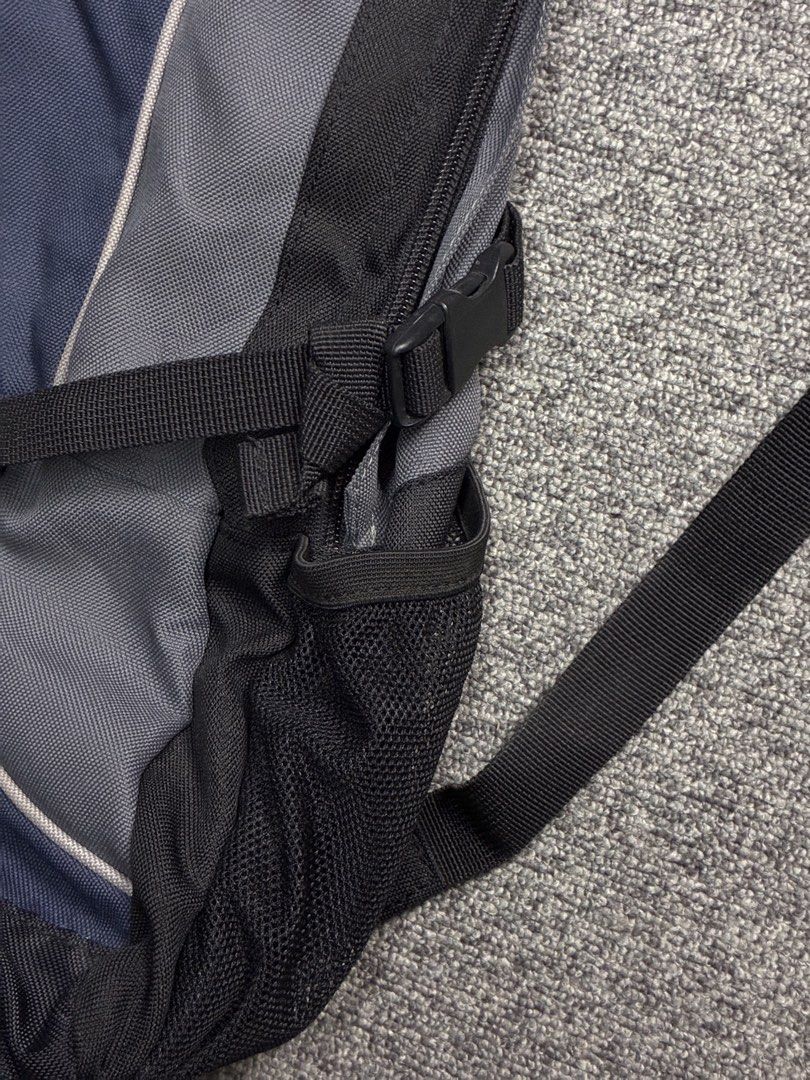 VNTG NIKE Y2K BACKPACK (Category: Backpacks) located in Manila. Submitted by garahe_secretshop (Listing ID 1457122832, Image 3). Description: - Vintage Nike backpack - Y2K era style - Color: Navy blue and grey - Features side mesh pockets - Waterproof - Missing pullers -Expired reflectorized .