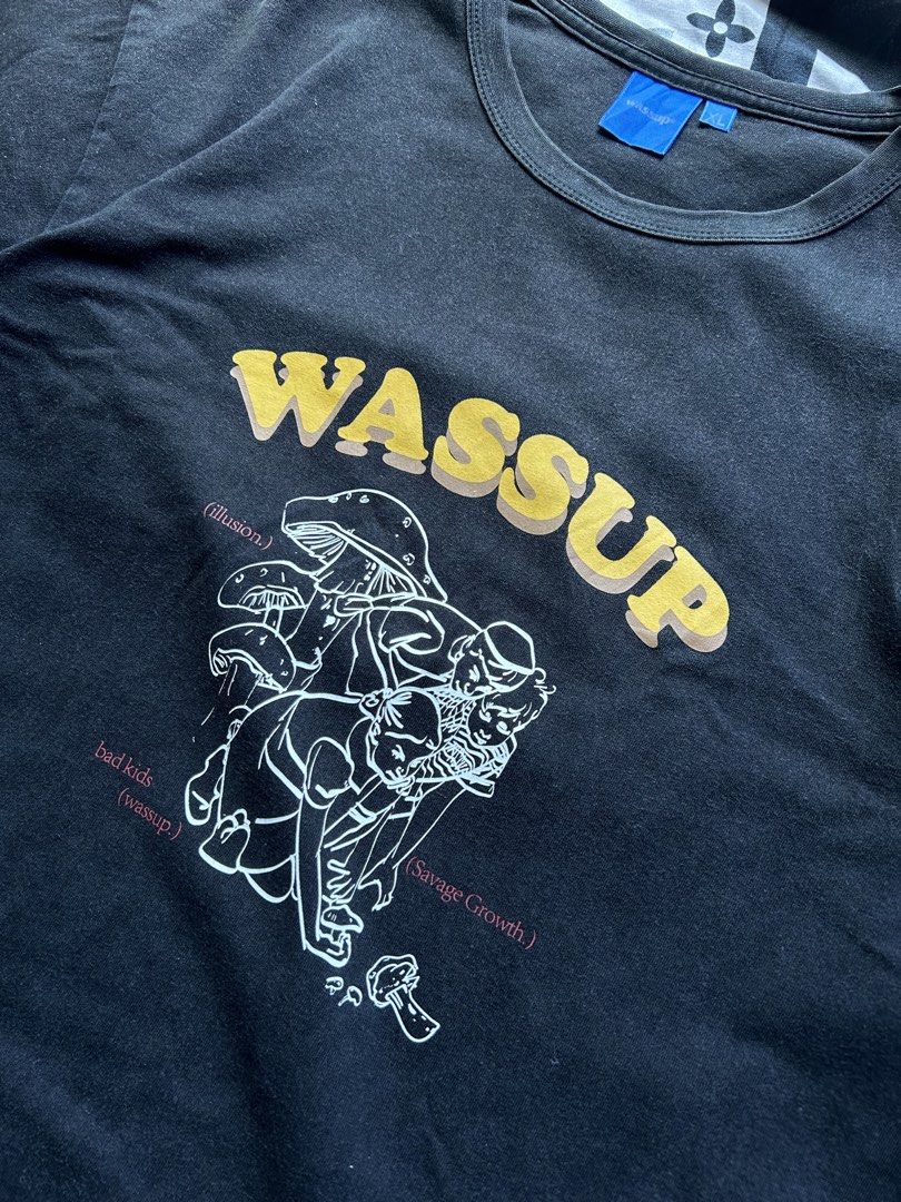 WASSUP Black Graphic T-Shirt (Category: Tshirts & Polo Shirts ) located in Davao. Submitted by culturecloset9 (Listing ID 1456956499, Image 2). Description: - Black WASSUP graphic tee - Features a cool mushroom and character design - Text details included - Ideal for casual wear - Dimes 21x27 XL Payment first + Shipping Fee Shipping shouldered by the buyer Standard Shipping : ₱99 MOP : Gcash Courier : J&T .