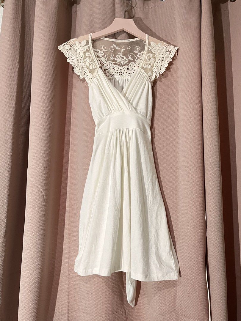 White Lace Cap Sleeve Wrap Dress (Category: Dresses) located in Davao. Submitted by sonateine (Listing ID 1457058866, Image 1). Description: - Cute white dress with elegant lace detailing. - Flattering wrap front design. - Gathered waist for a defined silhouette. - Delicate lace cap sleeves. - Flowy, knee-length skirt. - Adjustable tie at the back. - Versatile for casual outings or special events..