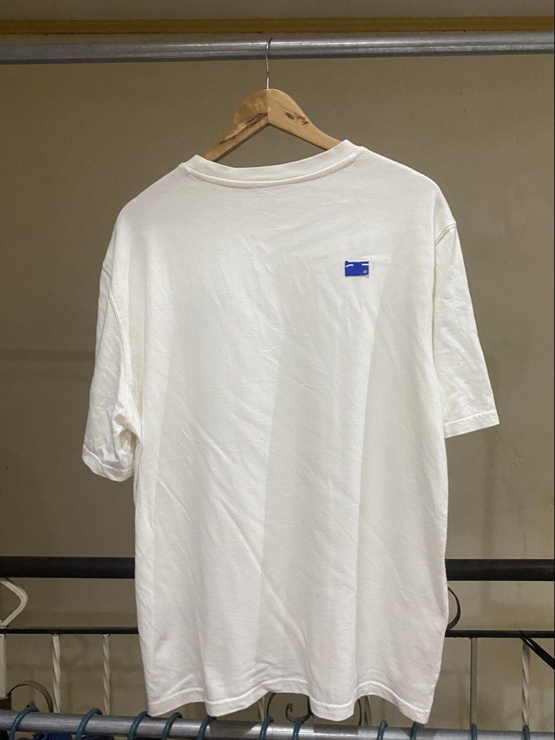 White T-shirt with Blue Graphic Logo (Category: Tshirts & Polo Shirts ) located in Rizal. Submitted by channzy (Listing ID 1456999035, Image 2). Description: - Crisp white t-shirt - Small, unique blue graphic logo on the chest - Distinctive bird logo tags - Simple and clean aesthetic - Ideal for casual everyday wear.