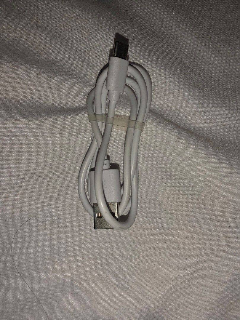 White USB-C to USB-A Charging Cable (Category: Chargers & Cables) located in Caloocan City. Submitted by mluck (Listing ID 1456968877, Image 1). Description: - White charging cable - USB-C to standard USB-A connector - Ideal for charging phones and other devices - Cable is neatly coiled.