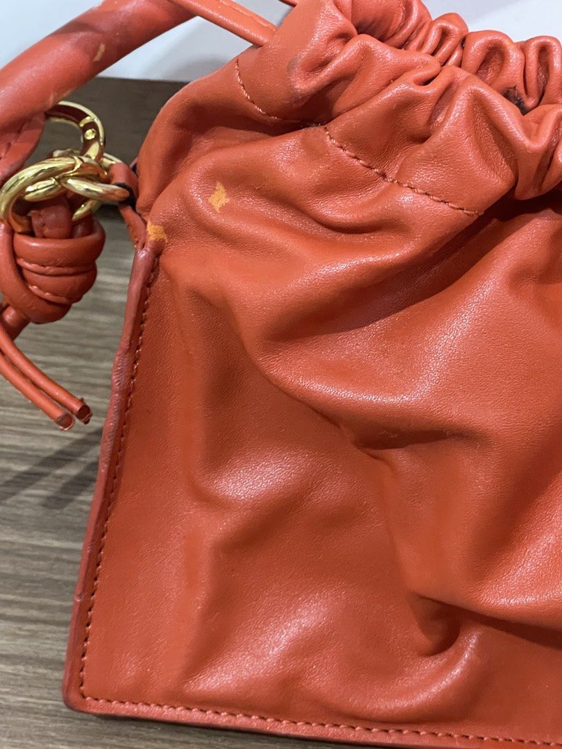 Yuzefi Orange Leather Drawstring Handbag (Category: Luxury Bags & Wallets) located in Quezon City. Submitted by cm_preloved (Listing ID 1456986771, Image 3). Description: - Authentic Yuzefi orange leather handbag - Secure drawstring closure - comes with long strap for crossbody wear - Comes with original dust bag - has leather rubs and peeling hence the low price Original price is 26k.