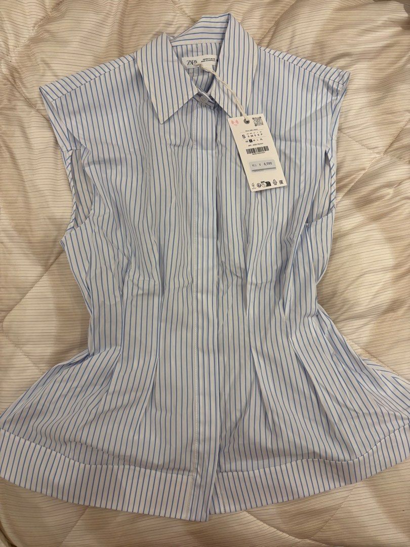 Zara Striped Sleeveless Shirt (Category: Shirts) located in Quezon City. Submitted by kindakristelle2481 (Listing ID 1457118752, Image 1). Description: - Zara sleeveless shirt - White and blue stripes - Button-up front with collar - Flared hem for a flattering fit - Size S - Brand new with original tags attached.