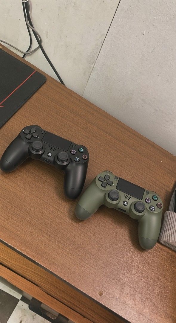 2x PS4 DualShock Controllers - Black & Green (Category: Controllers) located in Cebu City. Submitted by mopalitunta (Listing ID 1457285515, Image 1). Description: - Two (2) PS4 DualShock Wireless Controllers - Colors: 1 Black, 1 Olive Green - Condition: Good, working order - Perfect for your next gaming session!.