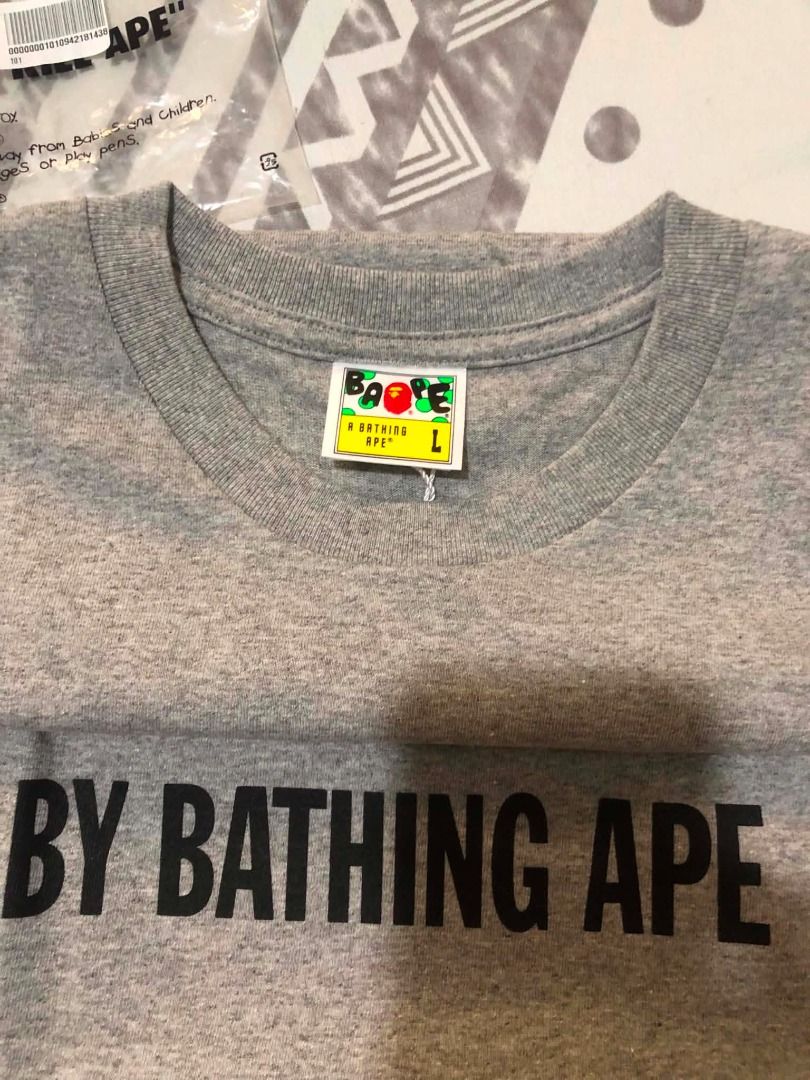 A Bathing Ape BAPE Grey Ape Head T-Shirt (Category: Tshirts & Polo Shirts ) located in Navotas City. Submitted by rivsmerc (Listing ID 1457251127, Image 3). Description: - Grey BAPE t-shirt - Features iconic ape head graphic - 'BY BATHING APE' text detail - Small BAPE logo tag on sleeve - Comes with original packaging - Ideal addition to any streetwear collection.