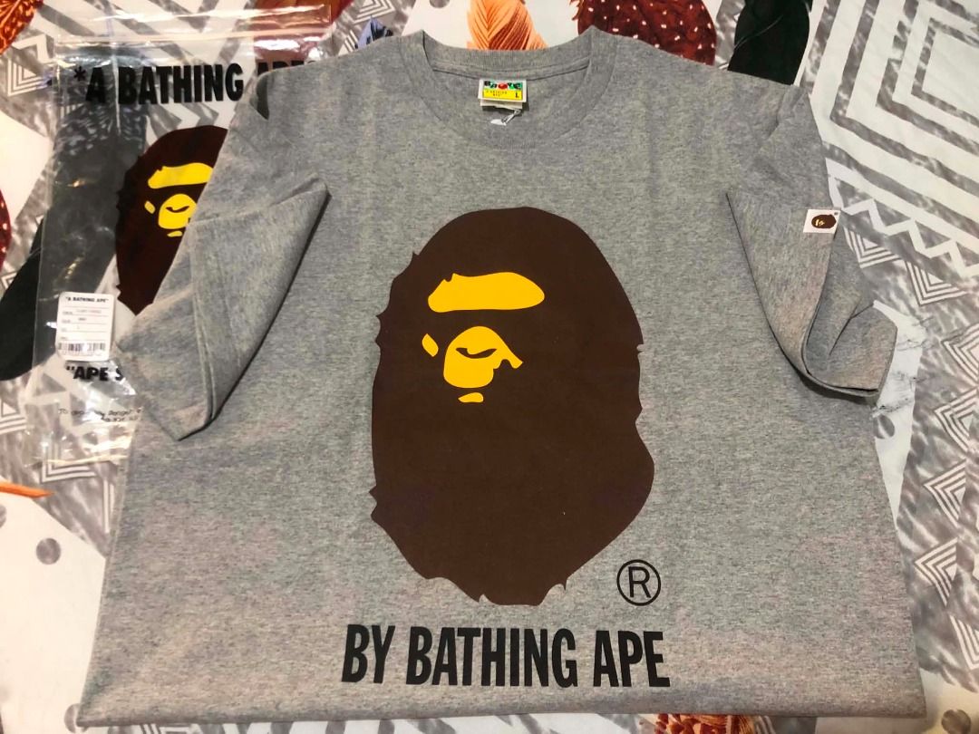 A Bathing Ape BAPE Grey Ape Head T-Shirt (Category: Tshirts & Polo Shirts ) located in Navotas City. Submitted by rivsmerc (Listing ID 1457251127, Image 1). Description: - Grey BAPE t-shirt - Features iconic ape head graphic - 'BY BATHING APE' text detail - Small BAPE logo tag on sleeve - Comes with original packaging - Ideal addition to any streetwear collection.